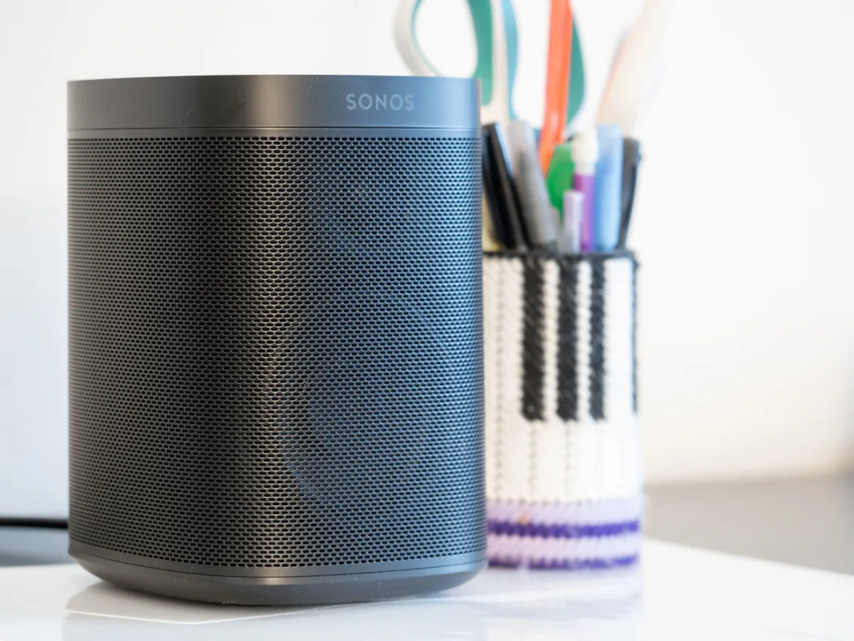 Black Sonos One wireless speaker on a desk